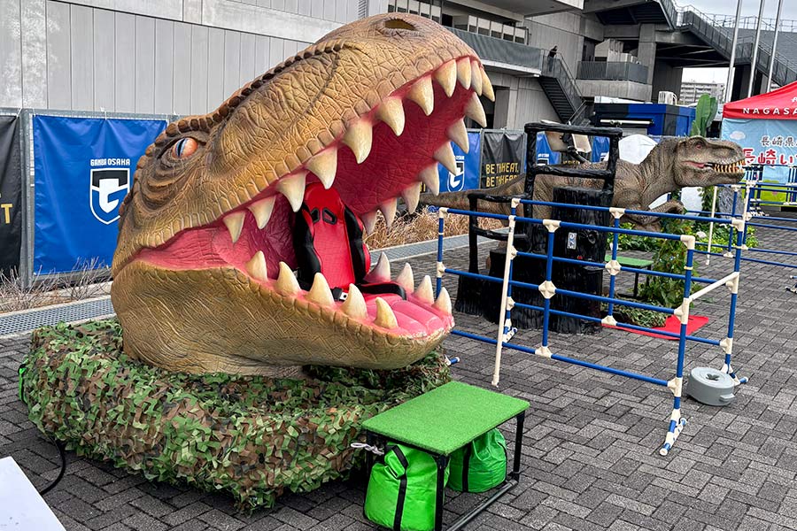 ティラノサウルスの口の中に座って大きく揺れる恐竜ヘッドチェア